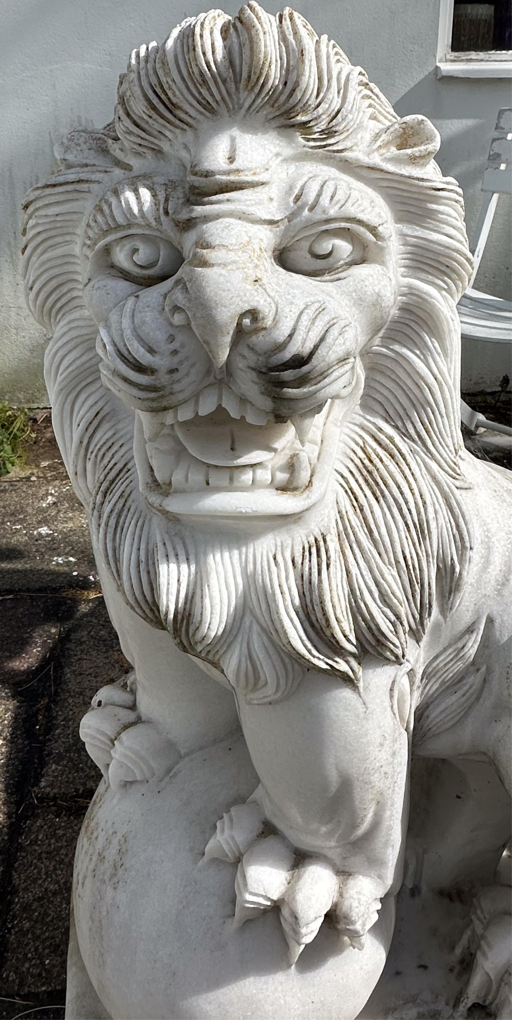 A pair of reconstituted white marble models of lions rampant